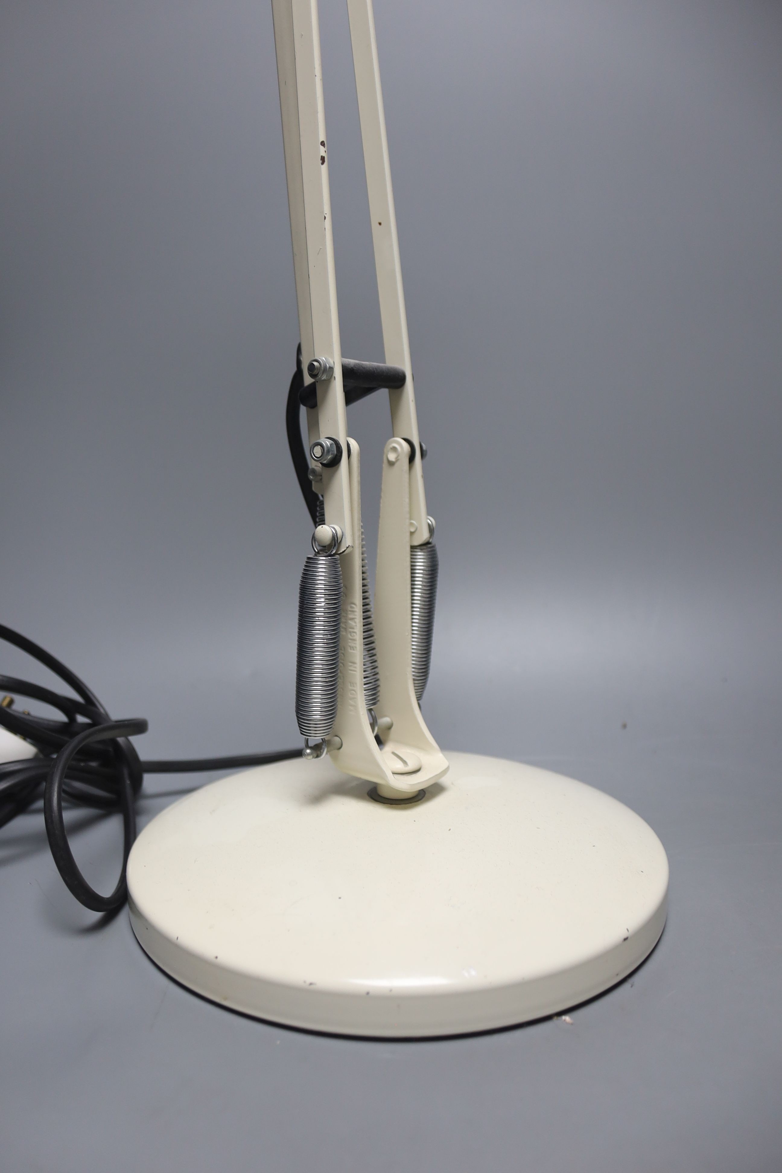 A cream anglepoise lamp, 83 cms high.